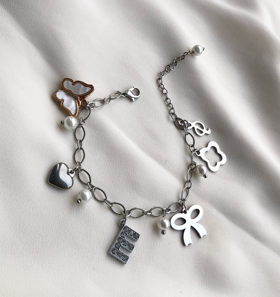 Silver charm bracelet 
N14,000