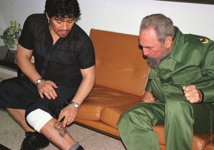 Diego Maradona shows Fidel Castro a tattoo of him, 2001.