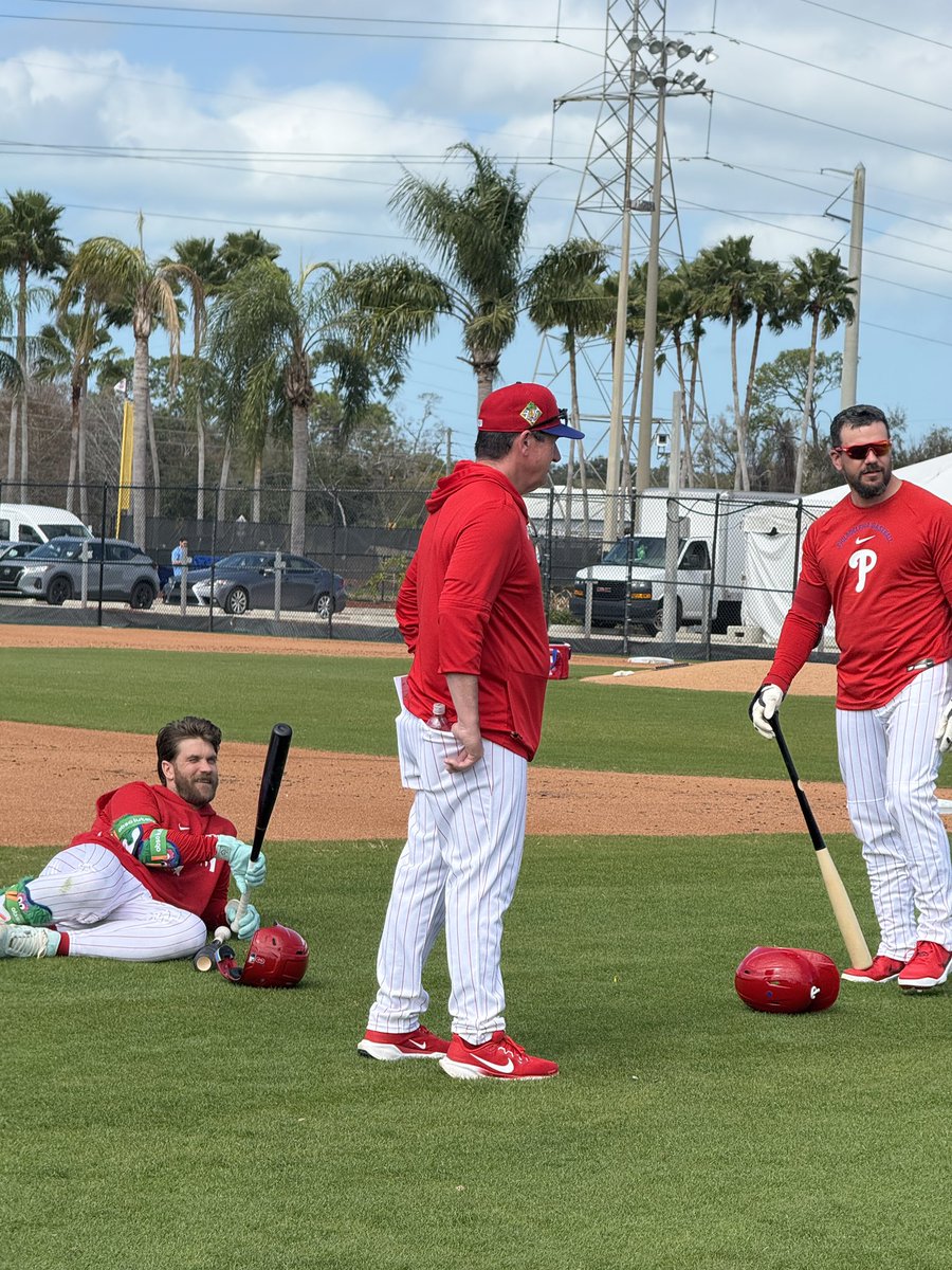 Harper (with his Phanatic gear), Rob Thomson and Schwarber hanging out before live BP.