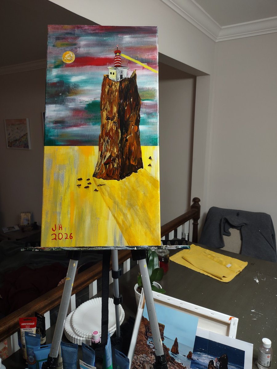 A quiet lighthouse above a still golden sea