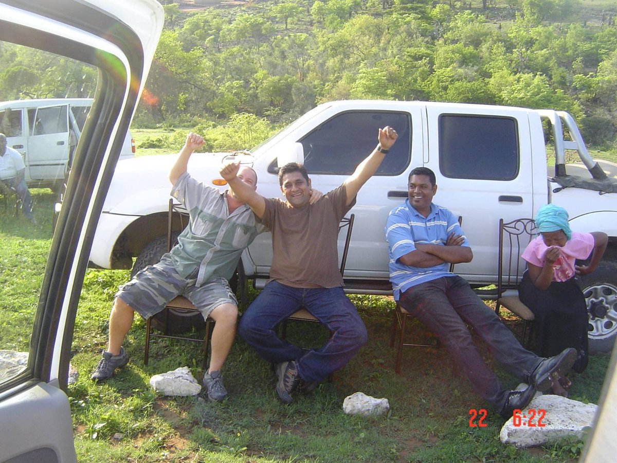 Sentletse's tweet image. These white men photographed themselves celebrating after killing the husband of the black woman sobbing next to them.

Testimony by Adv. Sello Maema is that these were members of the Cato Manor police rogue unit, under John Booysen’s command. They budged into the house, found