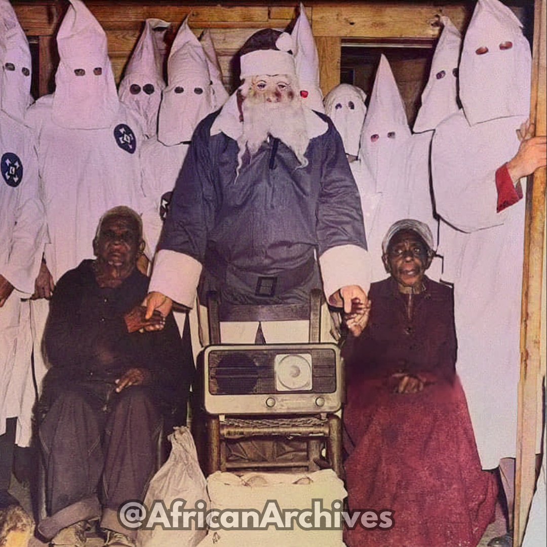 107-year-old Jack Riddle and his wife, Rosie, both formerly enslaved, in front of a group of Klansmen (one dressed as Santa Claus)  gifting them a radio in Talladega, Alabama, 1948.

It depicts an apparent show of “charity” on the part of the KKK for a photo opportunity.