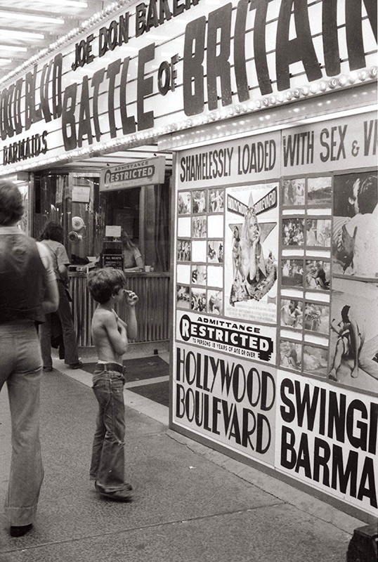 Young boy checking out the coming attractions at the Rio Theatre in Toronto, mid-1970s.