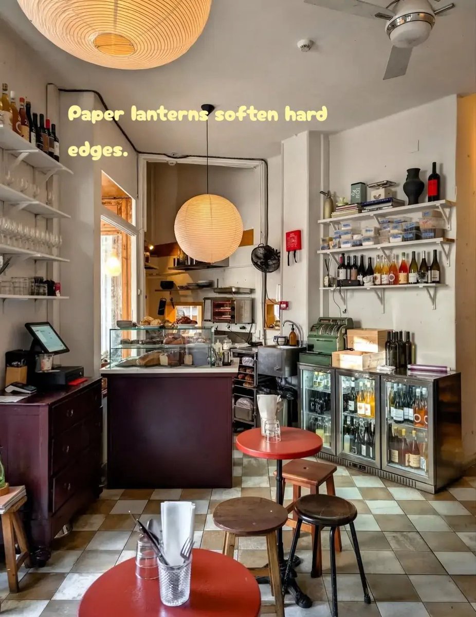 TOLLIstudio's tweet image. Red tabletops punctuate the room.
Open shelving keeps function visible.
Paper lanterns soften hard edges.
In tight spaces, vertical storage and lighting scale define comfort.

#CafeInterior #SpatialClarity #DesignFocus