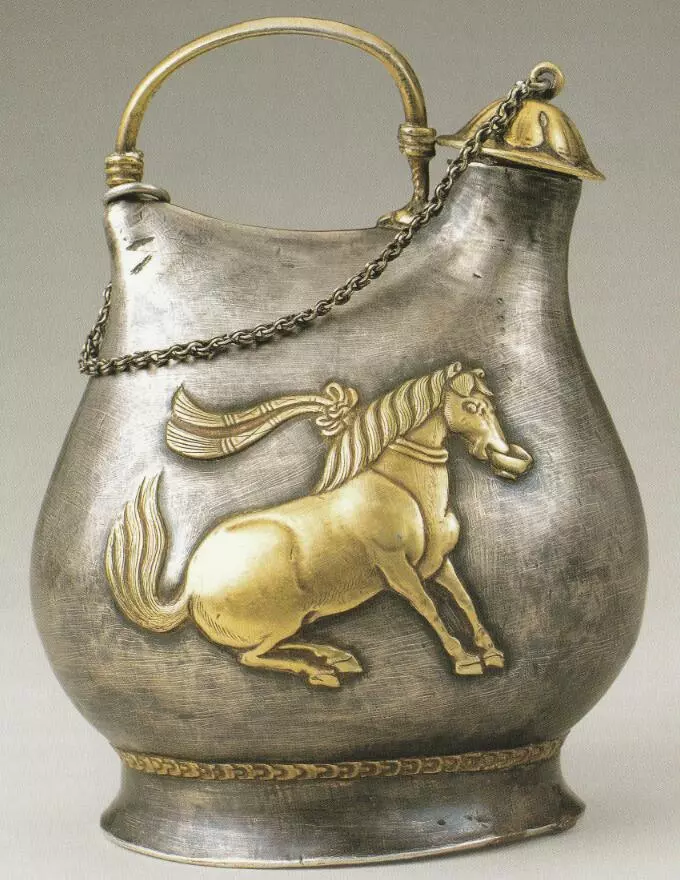 MuseumsChina's tweet photo. Dancing horses were a popular form of entertainment in the Tang Dynasty (618-907). On each side of this silver kettle, a gilded dancing horse is hammered in relief using a repoussé technique. The horse is strong and plump, captured in a moment of motion, with front hooves straight and firm, hind legs bent, and a wine cup grasped in its mouth. The spirited steed seems to embody the confidence and flourishing energy of the High Tang era. Collection: Shaanxi History Museum.