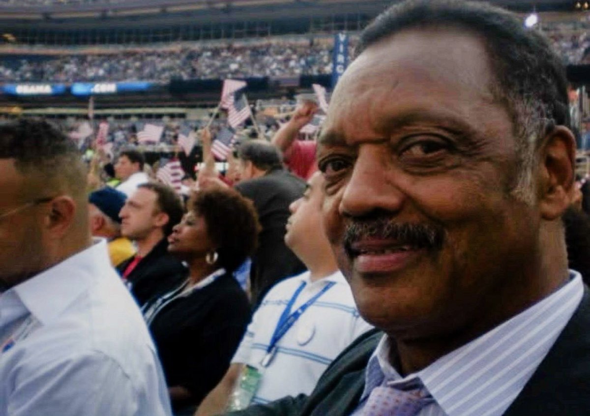 Jesse Jackson, in a crowd of delegates, press, and handlers at the Democratic National Convention pit in Denver, Colorado. August 28, 2008.