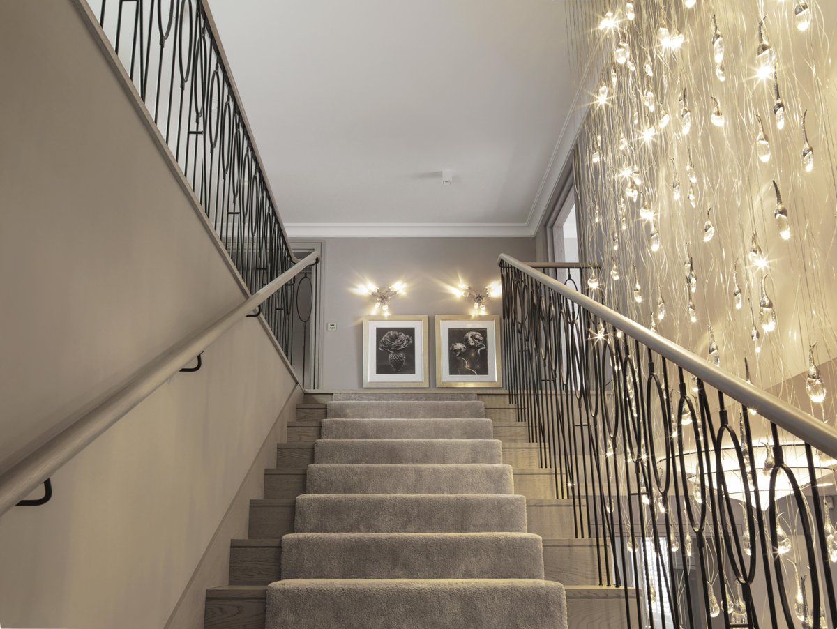 kellyhoppen's tweet photo. A staircase is the spine of the house, so it needs presence. A full-height cascade of glass draws you up through the space, while the wall lights sit above the beautiful artwork. Custom lights by Ochre #staircase #lighting #interiordesign https://t.co/qQsPI9qPDs
