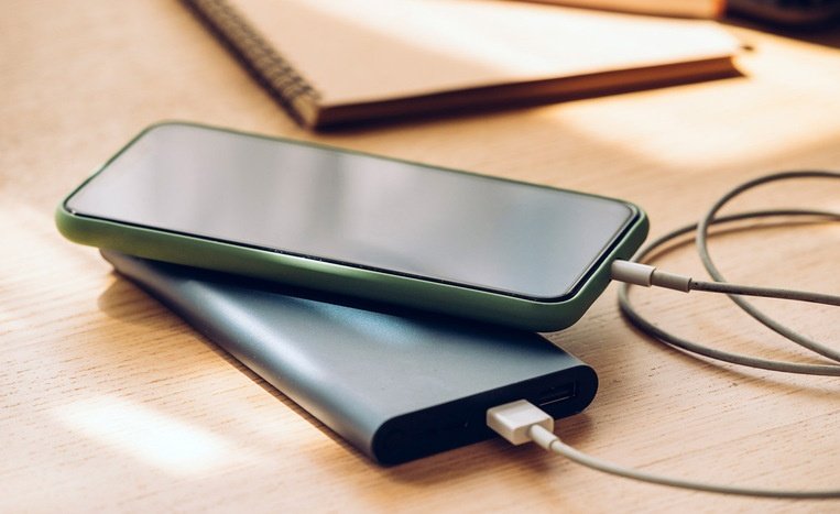 mfclothingceo's tweet photo. There is this my colleague that hardly shares his power bank.

This guy has two power banks.

Anytime you see him, his phone is permanently glued to one power bank. Once that one dies, he will switch to the second one immediately.

If you ask him, “Please, can you help me with your power bank?”

He will say, “My phone is low. It will soon off.”

I have never asked him before o. This is what he tells other people.

Now yesterday, we didn’t have light at home. I came to work, and still no light at the office. 

My phone was low, and I knew he was the only one that came with a power bank...

He entered the office as usual, with his phone and power bank attached together. 

So I asked him, “Please help me with your power bank.”

He replied, “My phone is low. It will soon off.”

I stretched my hand and pressed his phone and it was 90%.

I said, “No nah, it’s 90%!”

He still replied, “The phone is low, abeg.”

At that point I knew he was very stingy, and e vex me o.

A few minutes later, they sent him downstairs for an errand with two other guys, to go and bring in a new office table. 

Immediately he left, I quickly removed his cord and plugged my own phone. My charger is very fast, at least I will collect 5% before he comes back.

Then I looked at his phone and murmured: "Imagine saying your phone is low at 90%, stingy koko.”

Out of curiosity, I pressed his phone again and it was already off. 

Off ke!?

I said, “Ah ah?!”

I quickly removed my phone and plugged his own back.

And it started charging again—from 1%

ahhhh! 

Wetin I go explain give this guy now! 

I never know his phone was on a life support 🤭🤭