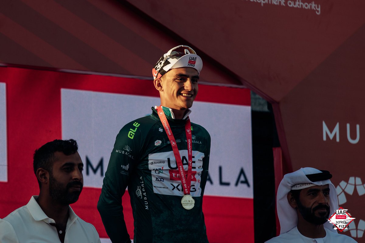 TeamEmiratesUAE's tweet photo. Podium duties called for @ISAACDELTOROx1 after stage 3 at the @uae_tour 😁

With a brave and determined display on the Jebel Mobrah, Isaac sits 🥈 overall. 

🤏🏻 21 seconds separate him from the lead.

#WeAreUAE | #UAETour https://t.co/AUoqkD2rw3