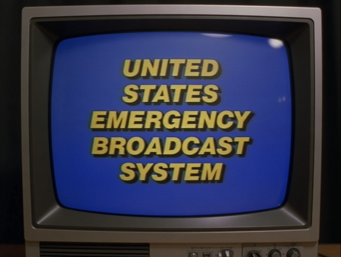 DON’T PANIC! URGENT INFORMATION!

THIS IS A MESSAGE FROM THE UNITED STATES EMERGENCY BROADCAST SYSTEM.

BY EXECUTIVE ORDER, ALL CIVILIAN COMMUNICATIONS ARE NOW UNDER FEDERAL CONTROL.

THIS IS NOT A TEST. EBS OVERRIDE.

ALL CHANNELS UNDER FED WATCH. UNKNOWN FORMATIONS OVER CITIES,
