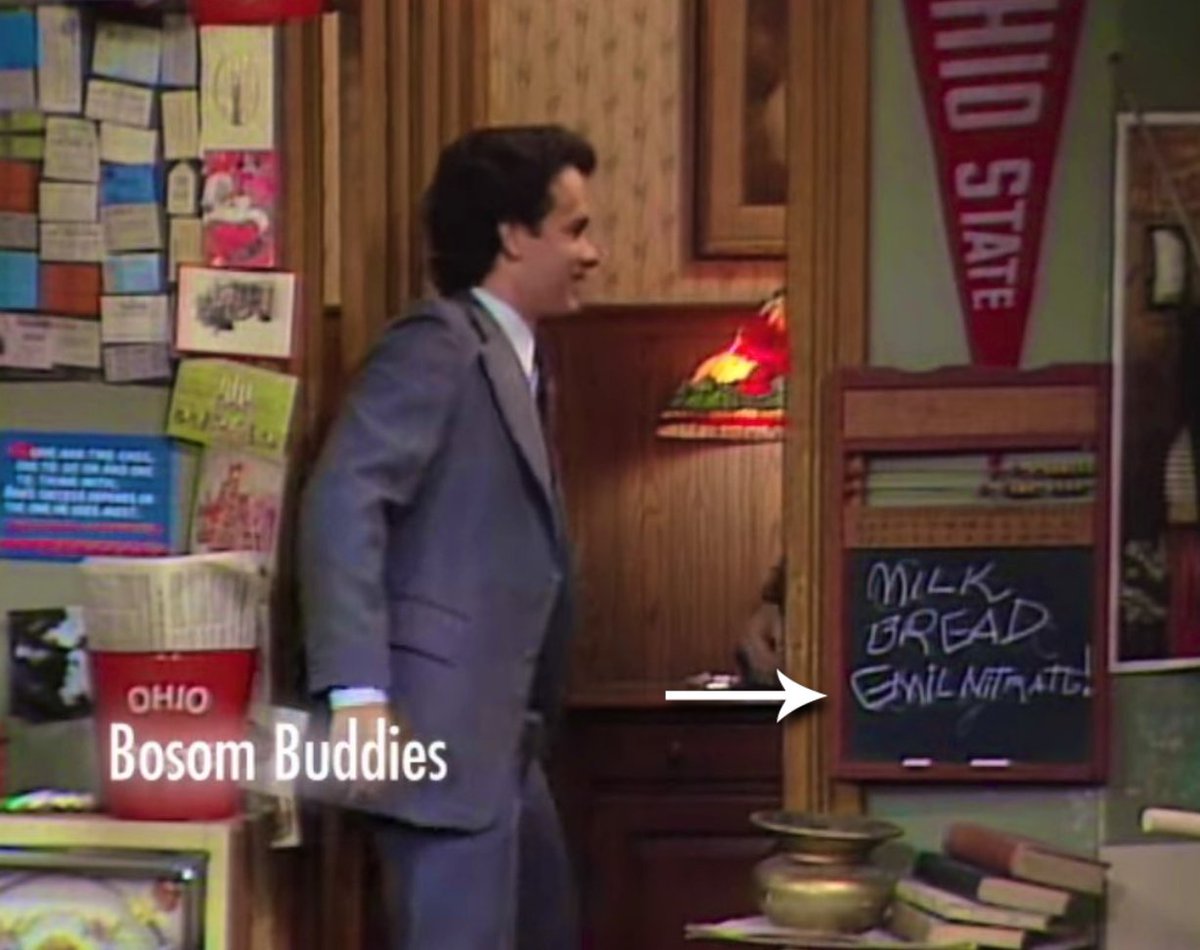 ‼️IN PLAIN SIGHT‼️this is a still from the opening  to the early 80's sitcom, Bosom Buddies, starring Tom Hanks.

👉 what's the third word on that little chalkboard and why is it there? 👀