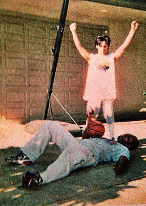 Prince stands victorious over Charlie Murphy during a game of basketball, 1985.