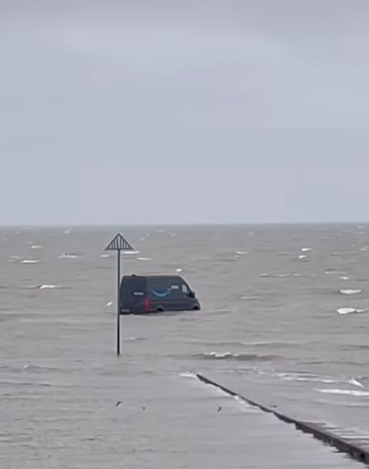Dexerto's tweet image. An Amazon van in England had to be rescued after the driver followed GPS directions which took them to a path that led into rising waters