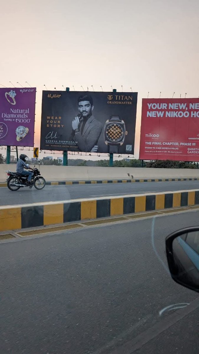 ChessbaseIndia's tweet photo. When travelling from the Bangalore airport into the city, keep your eyes peeled - you can spot the World Champion! :) https://t.co/9GYcysIHvB