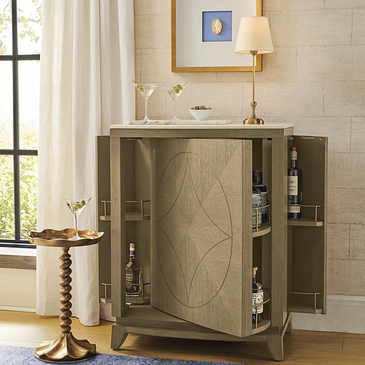 Party prep. 🍸 Springtime soirees are hitting the calendar. Get set with a bar station – like our sleek Wharton Revolving Bar Cabinet – that will dazzle guests. bit.ly/4qIEOP2