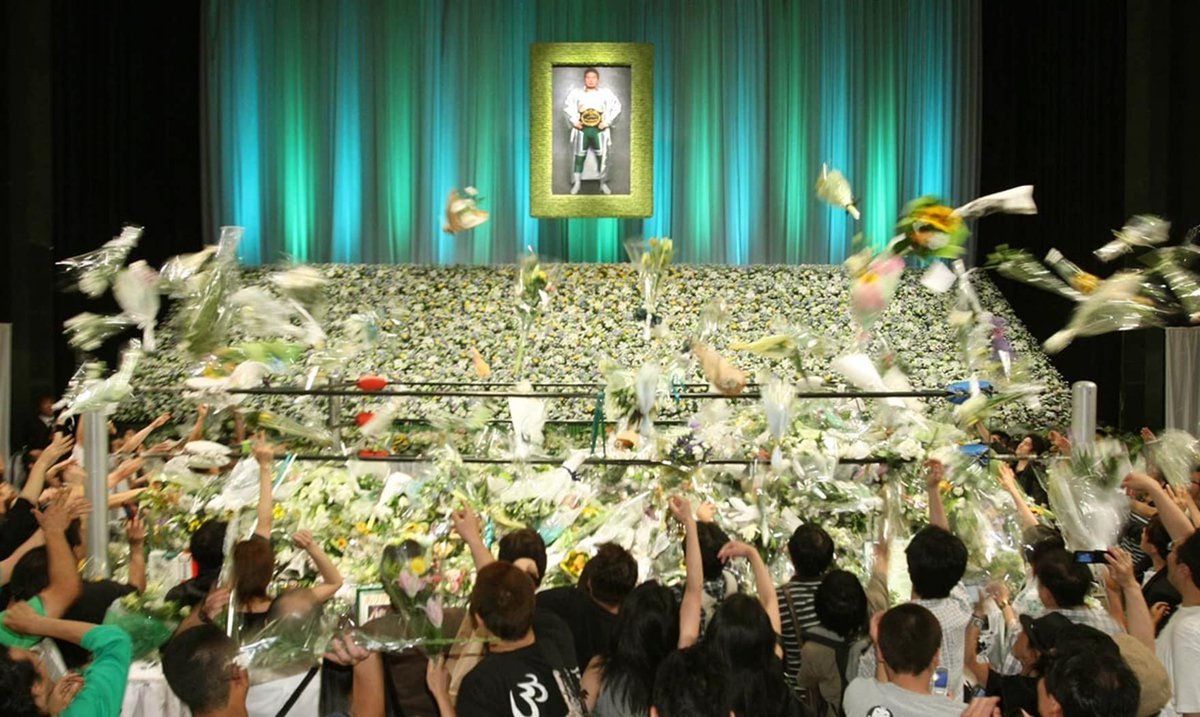 Mitsuharu Misawa's fans throw flowers during his fan ceremony following his passing.