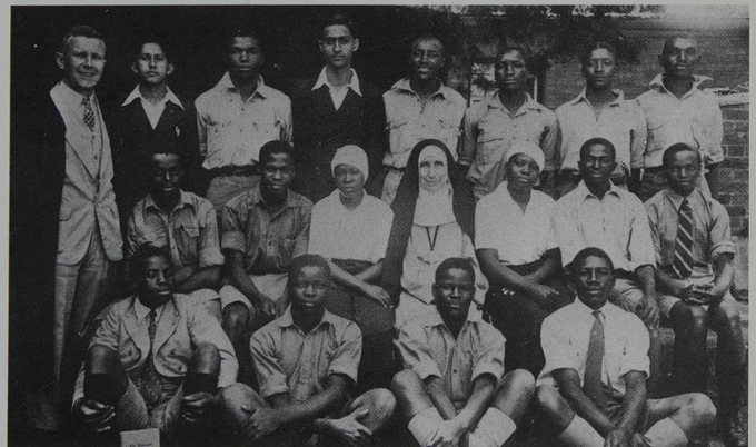The standard 7 class at St Peter's, c 1935, with class mistress and headmaster, Mr Shearsmith. Oliver Tambo is in the front row, second from right. Oliver Tambo would go on to be the top Maths and Science student in South Africa, prompting the government to probe his marks and