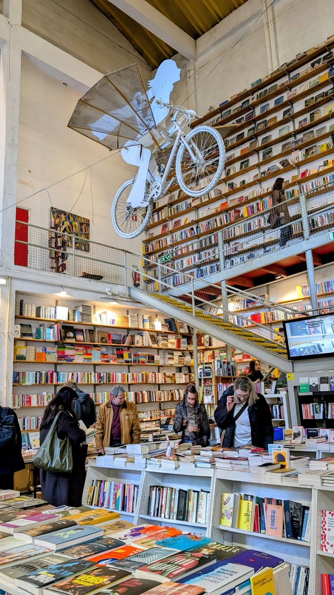 myartfoodtravel's tweet photo. Book lovers, this one’s special 📚✨
Ler Devagar at LX Factory is pure magic — towering shelves, a flying bicycle overhead, and that perfect old-printing-press vibe.
You pop in for a quick look… and leave an hour later with a new favourite read.
#LerDevagar #LXFactory #Lisbon #BookshopGoals