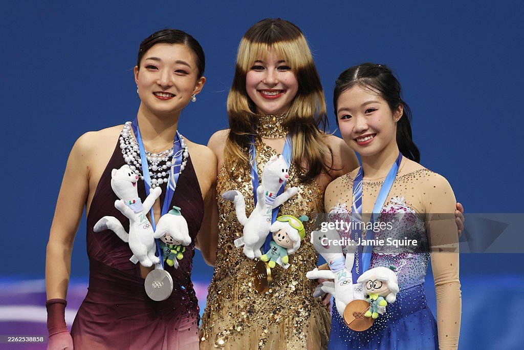 Gold medalist Alysa Liu of #TeamUnitedStates celebrates on the podium alongside silver medalist Kaori Sakamoto of #TeamJapan and bronze medalist Ami Nakai of Team Japan during the medal ceremony for the Women's Single Skating at the Milano Cortina 2026 Winter Olympics in Milan,