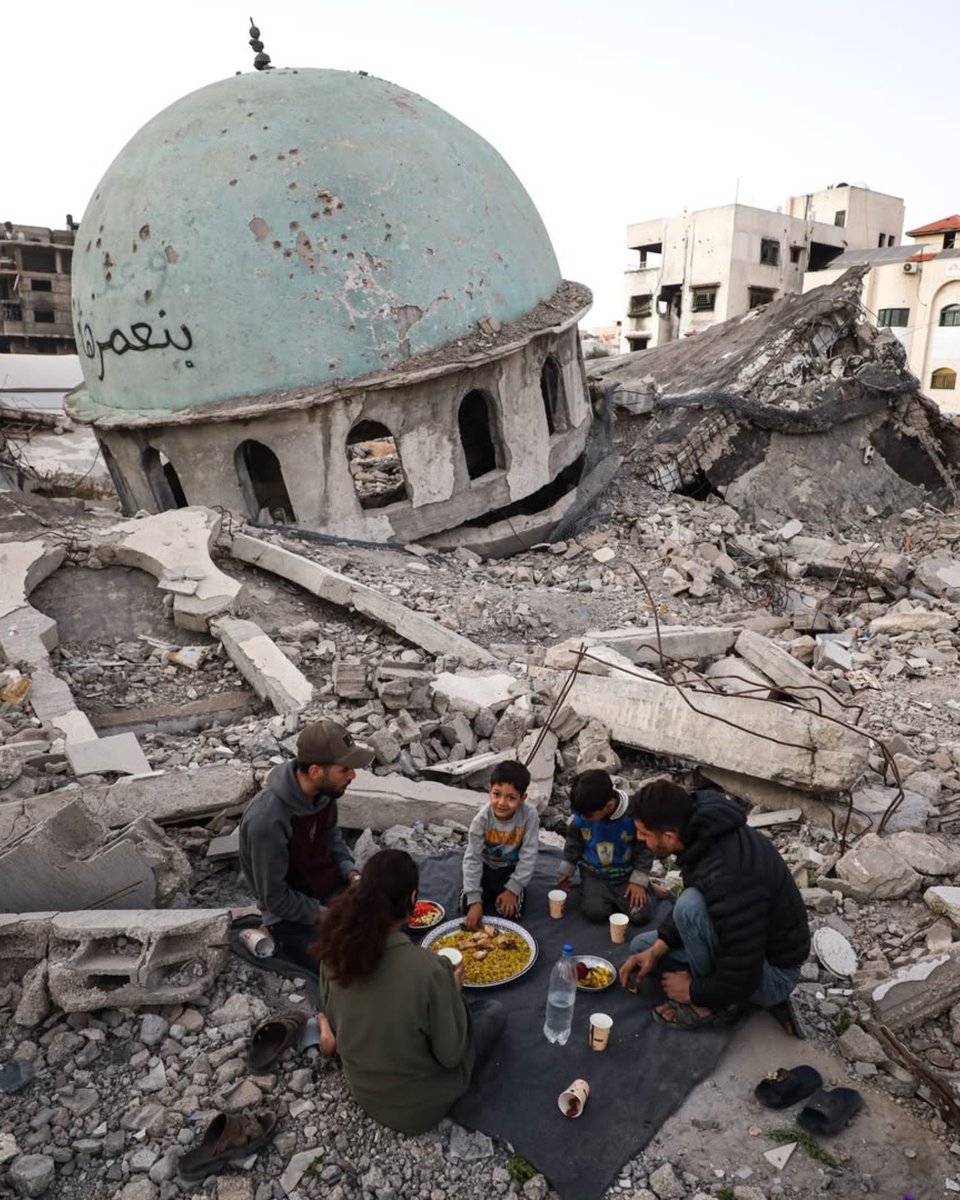 Sdizeeshan's tweet photo. 🇵🇸 A Palestinian family from Gaza gather to break their fast in the first iftar of Ramaḍān, around the ruins of El Abbas Mosque which was destroyed by the occupation forces. https://t.co/HCRN0Ofacd