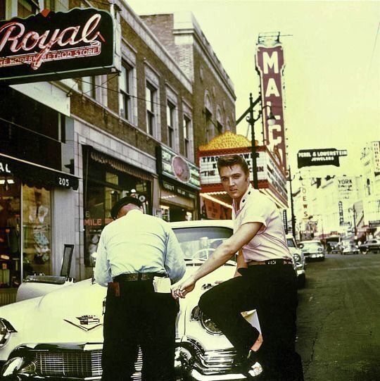 crockpics's tweet photo. Elvis Presley gets a parking ticket on Main Street outside Jim’s Barber Shop in Memphis, July 1956. Photo by Ger Rijff.  Even at 21 and on the verge of global superstardom, the King still had to follow the rules https://t.co/hmhXzQBKA1