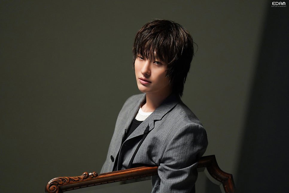 i settle into the quiet between shadows, a grey suit resting softly against my skin while dim light traces my face. my gaze drifts somewhere distant, calm yet heavy, like a thought unfinished, suspended in still air where silence feels louder than motion.