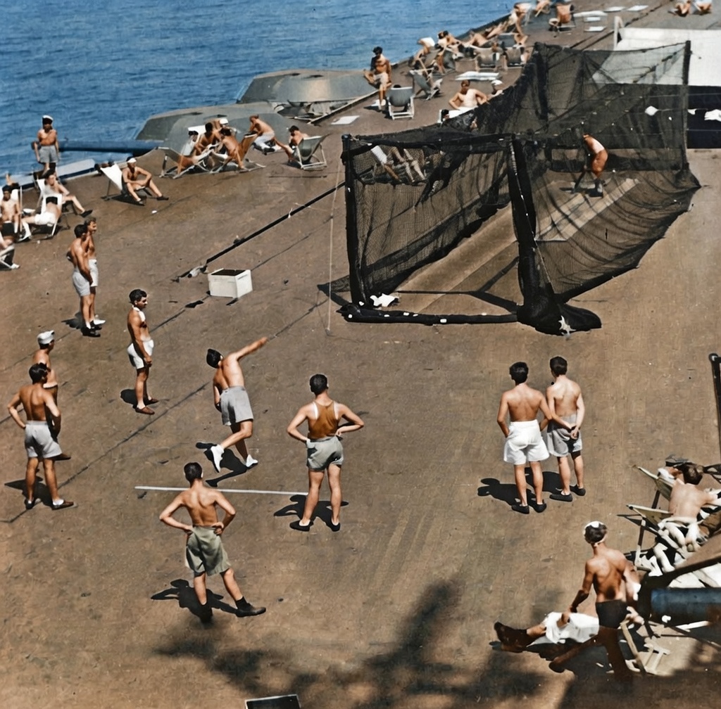 Australian servicemen play cricket on the flight deck of the aircraft carrier HMS Formidable in November 1945. The ship was carrying ex prisoners-of-war and civilian internees back from Japan to Sydney
