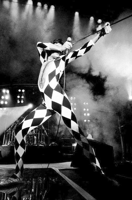 Freddie Mercury in his iconic harlequin suit, performing at Brondby Hallen in Copenhagen, May 12, 1977. Photo by Jorgen Angel. The photo show the theatrical brilliance of the A Day at the Races Tour.

#FreddieMercury #Queen