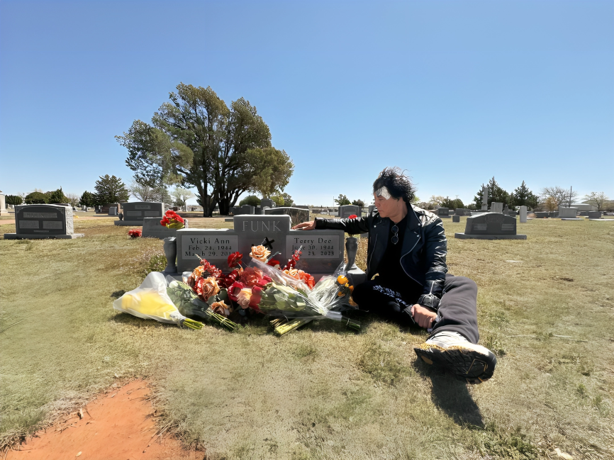 Atsushi Onita at Terry Funk's grave.