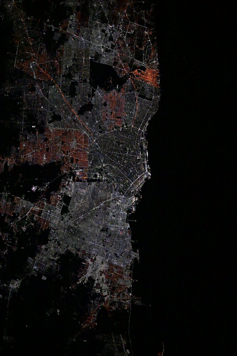 Buenos Aires, capital of Argentina is a beautiful sight from orbit! Most of the city has adopted white LED lighting, while older sodium vapor appears as orange-red patches on the outskirts of the metropolitan core.