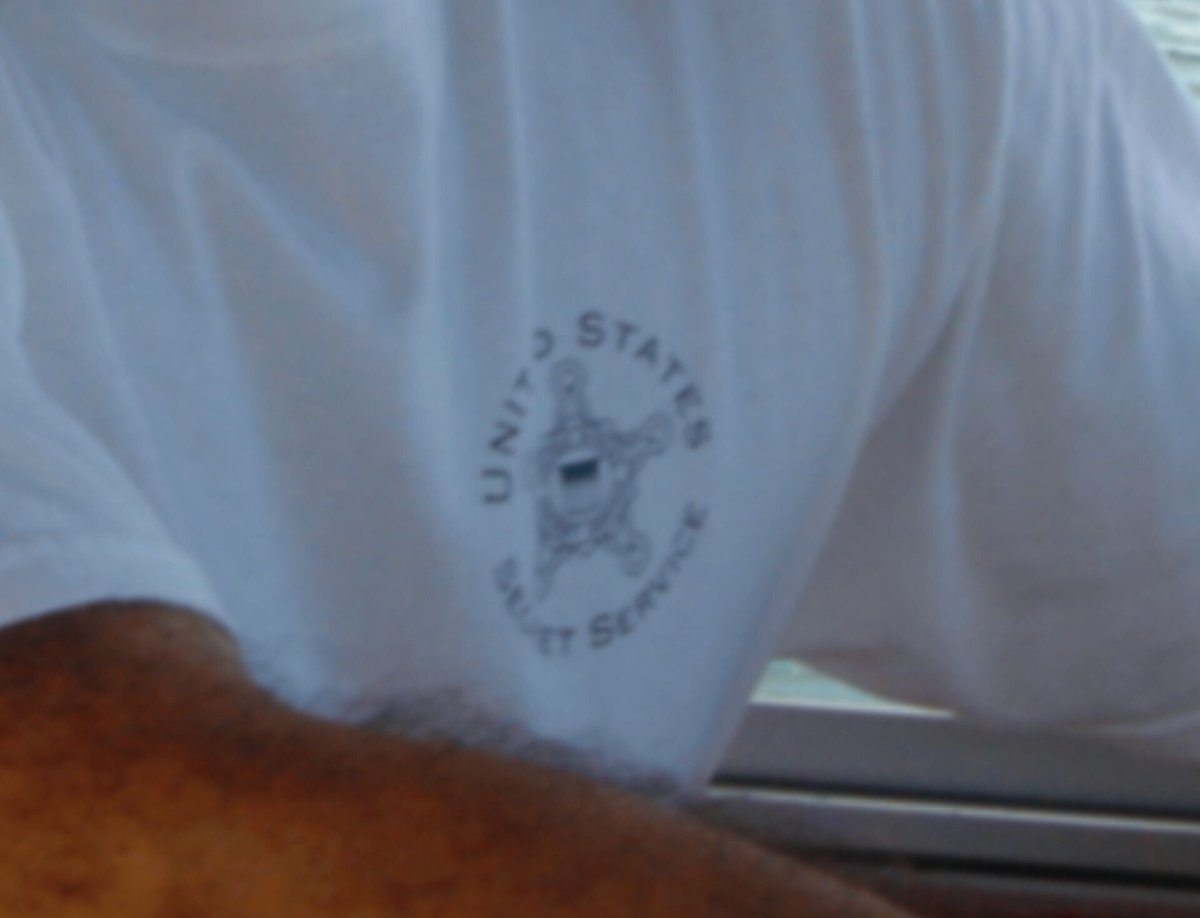 OunkaOnX's tweet image. Epstein is seen wearing a United States Secret Service shirt in recently released files