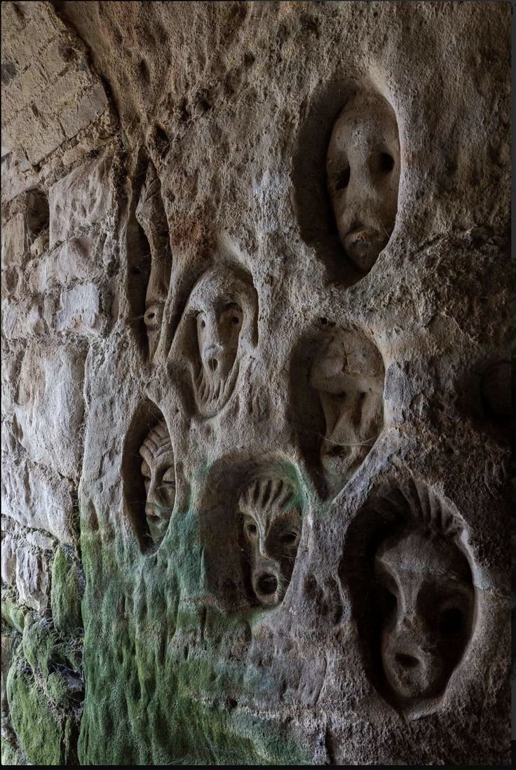These eerie faces are part of the mysterious medieval wall carvings found inside Royston Cave in Hertfordshire, England.