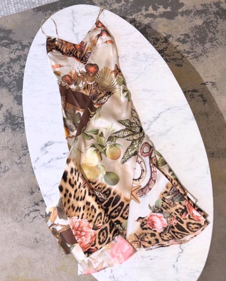 chelley bissainthe wearing a ss05 roberto cavalli seashell and animal print slip dress