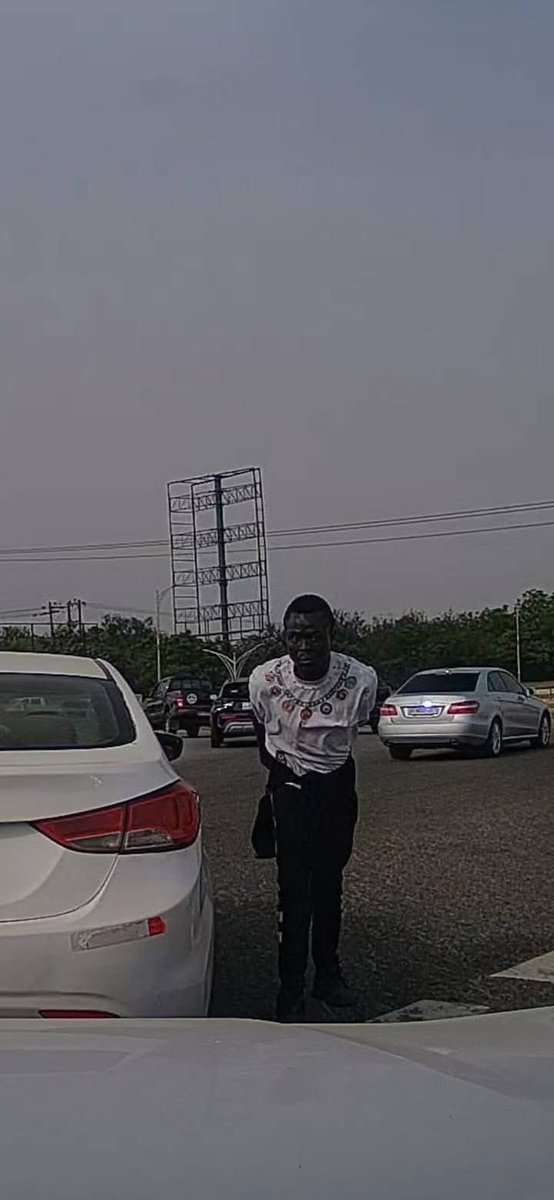 elormhood's tweet photo. Phone Snatching Incident Reported at Achimota Forest Overhead Roundabout in Accra

Accra, Ghana – Motorists are being urged to exercise heightened vigilance following a reported phone snatching incident at the busy Achimota Forest overhead roundabout.

According to an eyewitness account shared on social media, a female driver had her mobile phone stolen while stuck in traffic at the location. The theft reportedly occurred in broad daylight, with the perpetrator swiftly grabbing the device from the victim before fleeing the scene.

The witness, who was positioned directly behind the affected vehicle, captured video footage of the incident and shared clear snapshots of the suspected thief. The material has been circulated online in an effort to aid identification and prompt action.

“Please, everyone: always roll up your windows and stay alert when you're in traffic, especially around that area. Don't let yourself become the next victim,” the eyewitness advised in the post.

The Ghana Police Service has been publicly tagged and called upon to investigate the matter urgently and apprehend the suspect to prevent further occurrences in this high-traffic zone, which has seen recurring reports of similar opportunistic crimes.