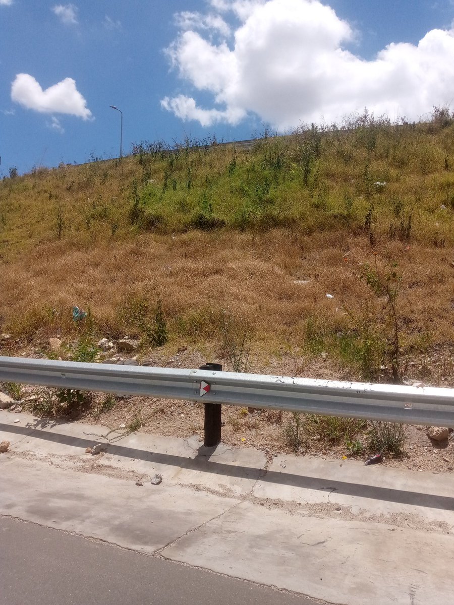 The image captures the dry, fading slopes of the TRABABALAS Interchange, a project that was once presented with pride, its embankments covered in fresh green grass symbolising renewal, progress and modern infrastructure. Less than a year later, the green has withered. What