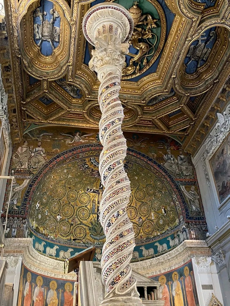 The interior of the Basilica of San Clemente in Rome, specifically looking towards the apse and altar.