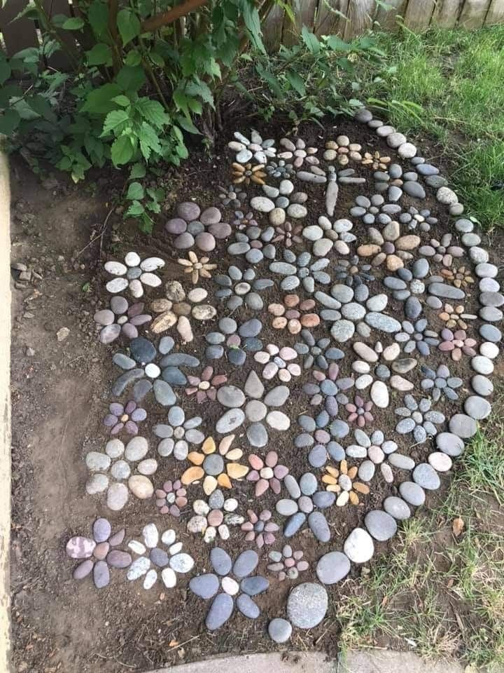 HerodotusWave's tweet photo. A rock flower garden, a creative DIY landscaping feature made by arranging various stones into floral patterns. https://t.co/Oyk7wSGViz