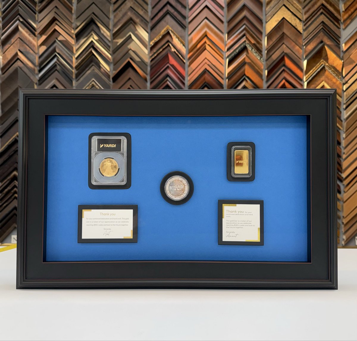 FrameArtShop's tweet photo. We were honored to create this shadowbox for Paul featuring commemorative gold coins presented by Yardi to celebrate the incredible milestones of $1B &amp; $2B in sales. Designed with the company’s signature blue, this piece transforms meaningful recognition into a timeless display. https://t.co/XzUShNmBi9
