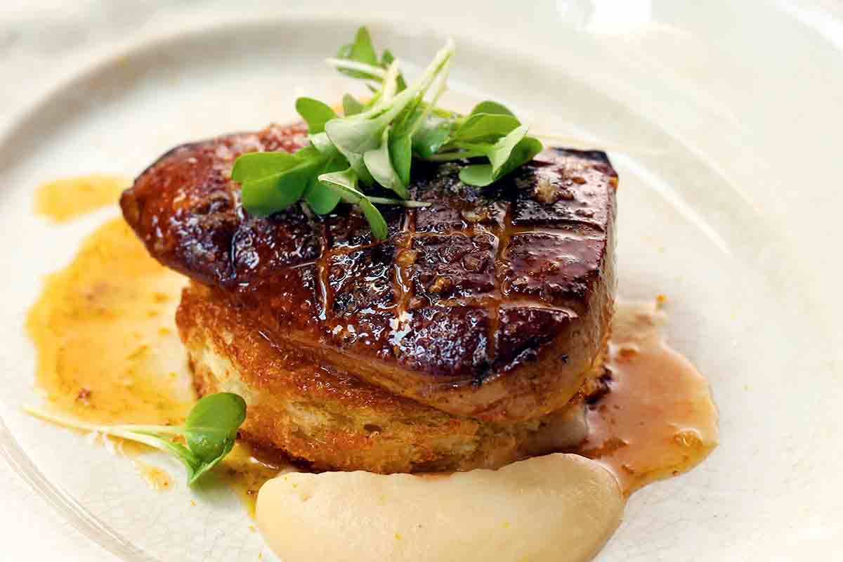 Foie gras 

Foie gras is a luxury delicacy in French cuisine, made from the liver of a duck (most commonly) or goose that's been fattened through a process called *gavage*—force-feeding via a tube inserted into the bird's esophagus multiple times a day. This causes the liver to