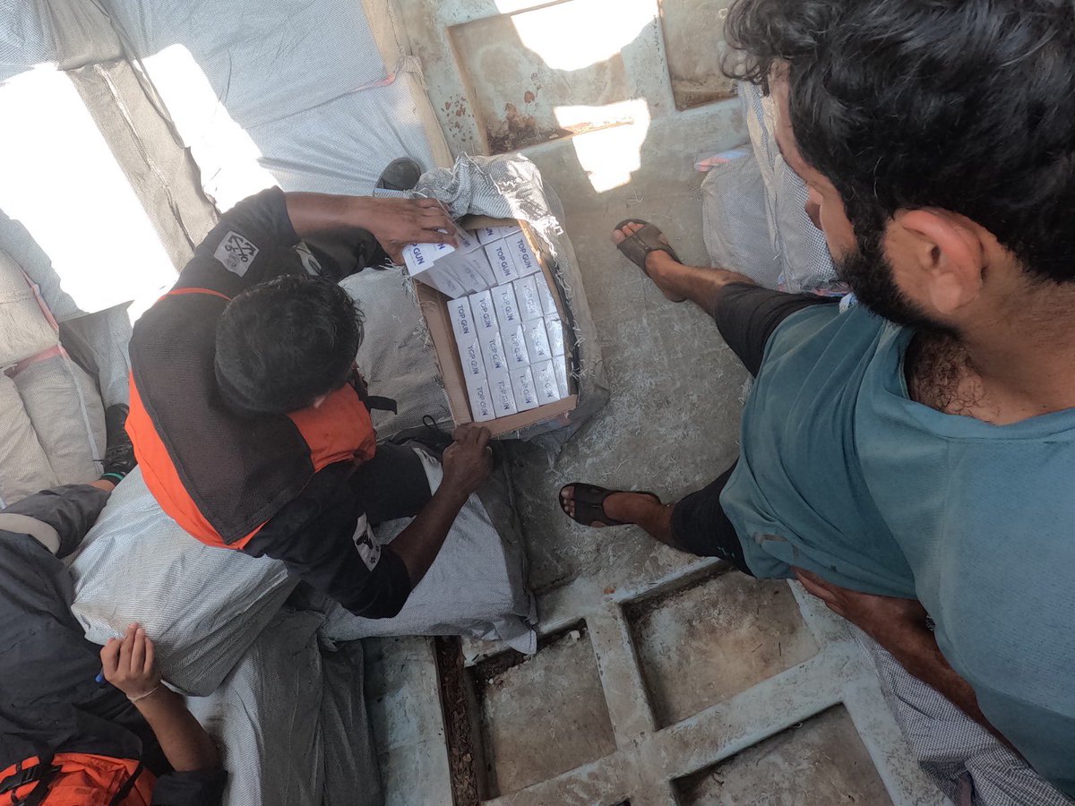 IndiaCoastGuard's tweet image. On 21 Feb 26, @IndiaCoastGuard ship intercepted a suspicious foreign boat inside the #Indian #EEZ, approximately 115 NM west of #Dwarka. The vessel, identified as Al Mukhtar, was manned by four #Iranian crew. On rummaging, 200 cartons containing about one lakh packets of foreign