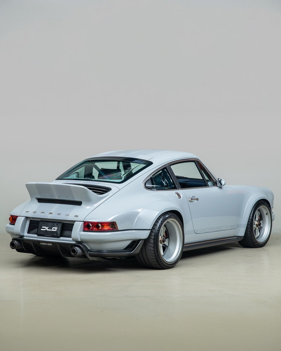 duPontREGISTRY's tweet photo. 1990 Porsche 911 Singer DLS "Dynamics & Lightweighting Study" | One of 75 examples created by Singer Vehicle Design

This 911 represents the pinnacle of naturally aspirated Porsche engineering. At its heart is a 4.0-liter air-cooled flat-six, producing 500 horsepower and revving to 9,000 rpm, developed in collaboration with Williams Advanced Engineering and the legendary Hans Mezger.

Weighing approximately 2,200 lbs thanks to extensive use of carbon fiber, magnesium, and titanium, it features Williams-engineered suspension, Brembo carbon-ceramic brakes, advanced aerodynamics, a Hewland magnesium 6-speed manual, and BBS magnesium center-lock wheels. Finished in Sport Classic Grey with ghosted stripes over a Dark Navy interior, showing just 1,337 miles since completion, and protected by full PPF, this Singer is a masterclass in lightweight design, precision, and craftsmanship.

Learn more: https://t.co/B7Xl5dX7mD