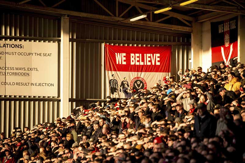 SwainyDylan's tweet photo. @Shoreham_boys89 Mainly like the ones pictured here but the Billy Sharp one as well. I'd love the whole back of the kop to be lined with flags that supporters put there. Having nothing within the stand except for a board of Ground Regulations seems almost like it's the kop from 1984. https://t.co/LZ73XqFks9