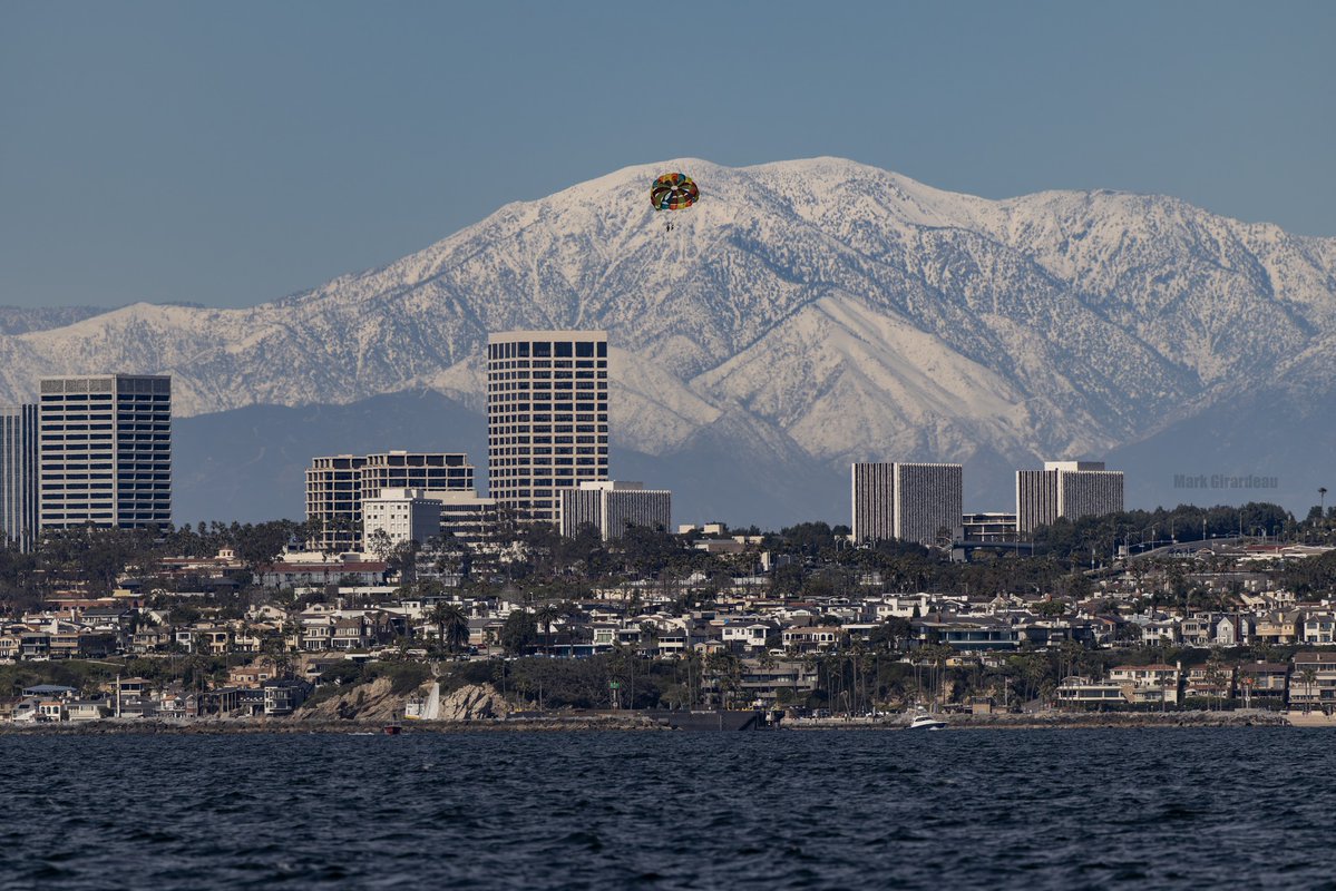 It's freezing in the Northeast. Meanwhile, in the post-apocalyptic hellhole California in February, there's no AI needed to show a parasailer over Newport Beach backdropped by snow-capped San Gabriel Mountains.

H/t to Mark Girardeau for capturing it.