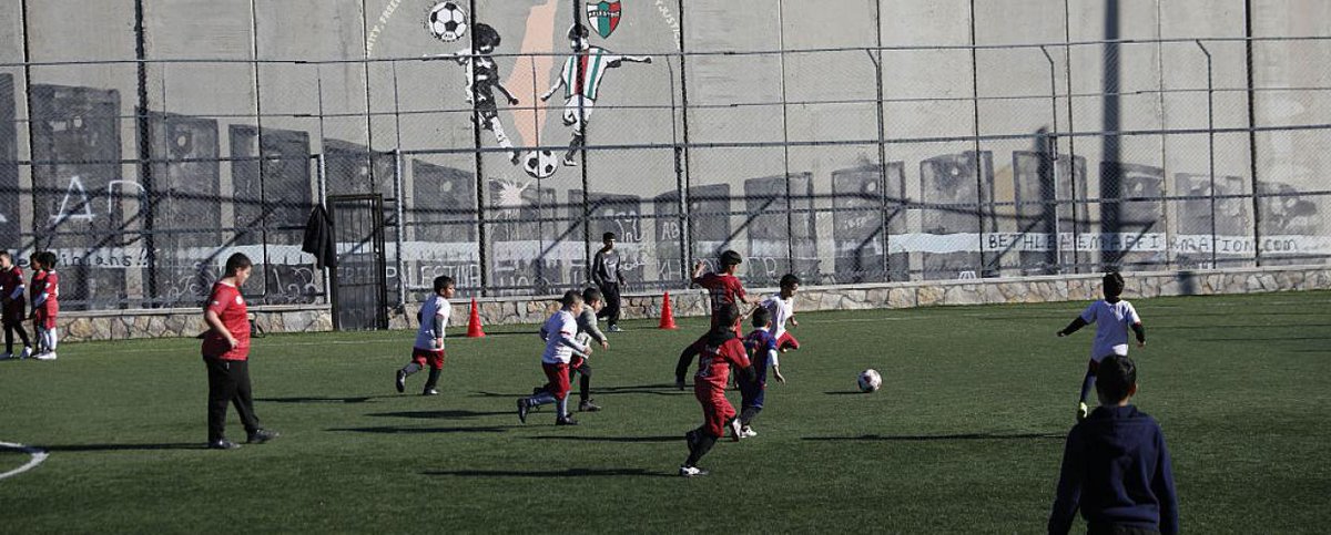 PalStudies's tweet photo. Israel’s threat to demolish Aida Camp’s football pitch shows how children’s play is targeted under occupation. @HindShraydeh traces how assaults on Palestinian sports are part of a wider system suffocating community life. https://t.co/WfE4wEnrbx https://t.co/LcSZBOyIMw