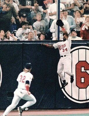 baseballinpix's tweet photo. Kirby Puckett leaps and makes an amazing catch at the wall during game 6 of the 1991 World Series. He would later hit the walk off home run to send things to the game 7. https://t.co/oqm8zeXwSf