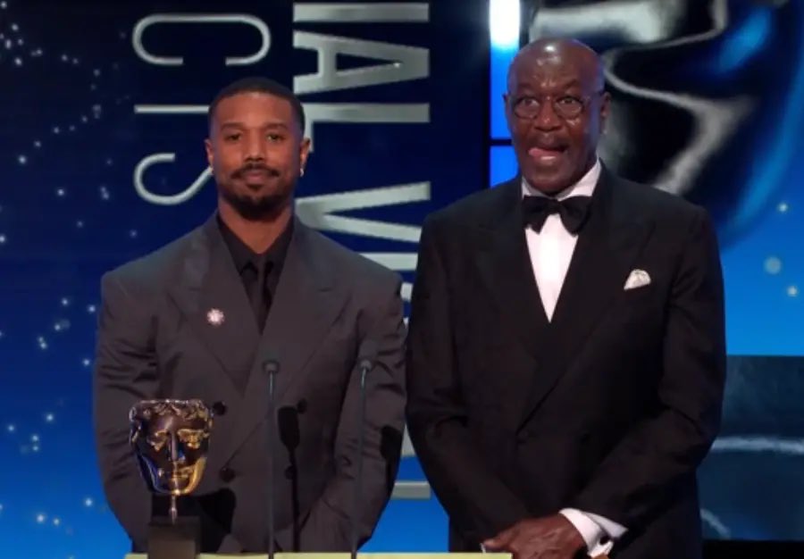 BAFTAs host Alan Cumming delivered a message after the ceremony was interrupted by Tourette’s campaigner John Davidson yelling the N-word while Michael B. Jordan and Delroy Lindo were on stage:

“You may have noticed some strong language in the background there, this can be part