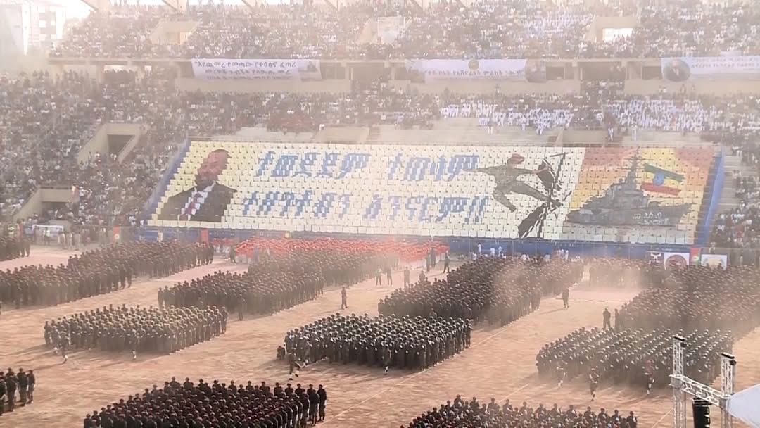 tesfanews's tweet image. #Context: 🚨 Today’s propaganda display features a bold slogan declaring, “Whether they like it or not, we will not remain landlocked.”  

Then, it shows a soldier smashing through a locked gate, forcing it open for a ship labeled “Assab Ethiopia” to come in through.

 It's a