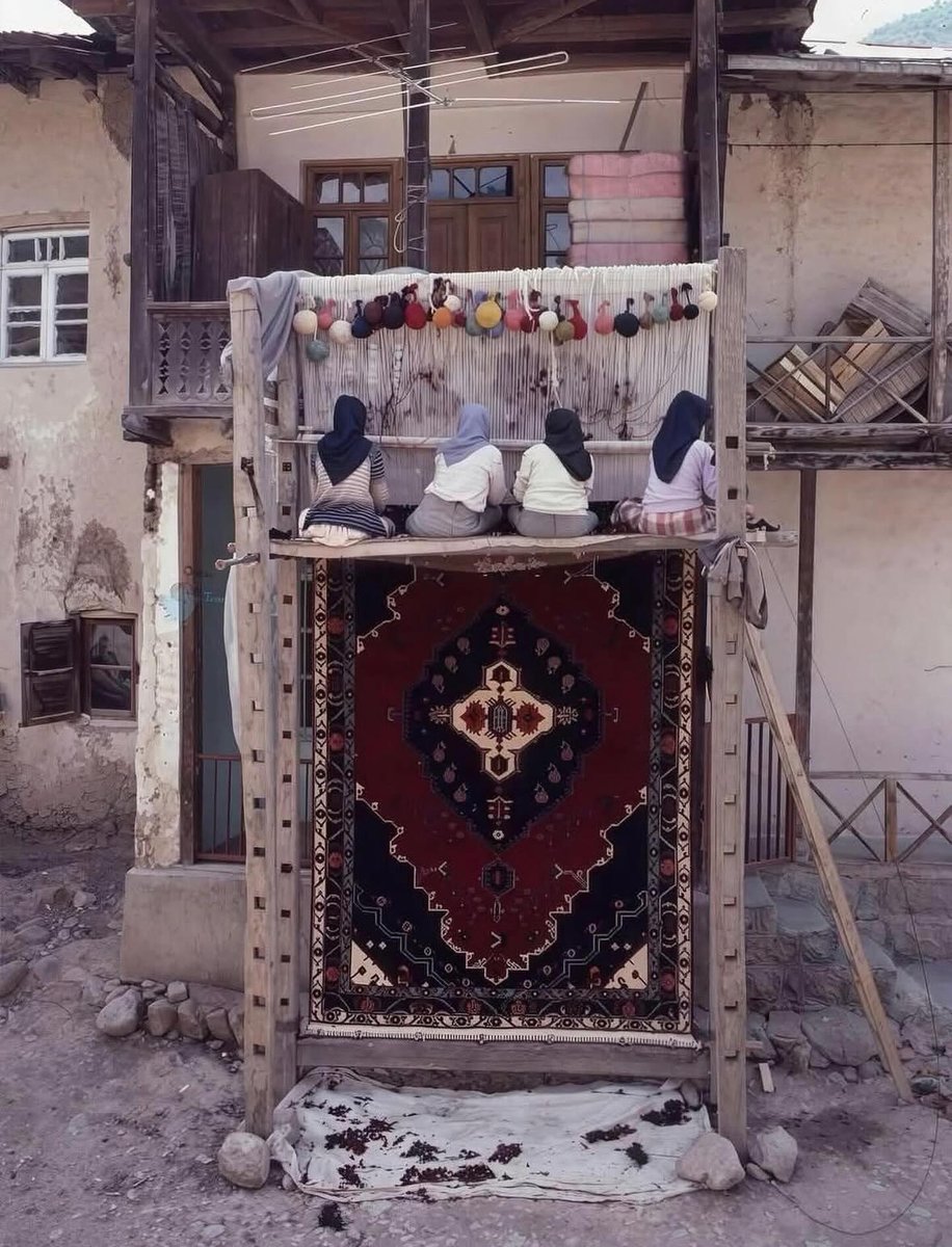 Women weaving a Persian carpet by hand in Kashan, Iran, 1989.