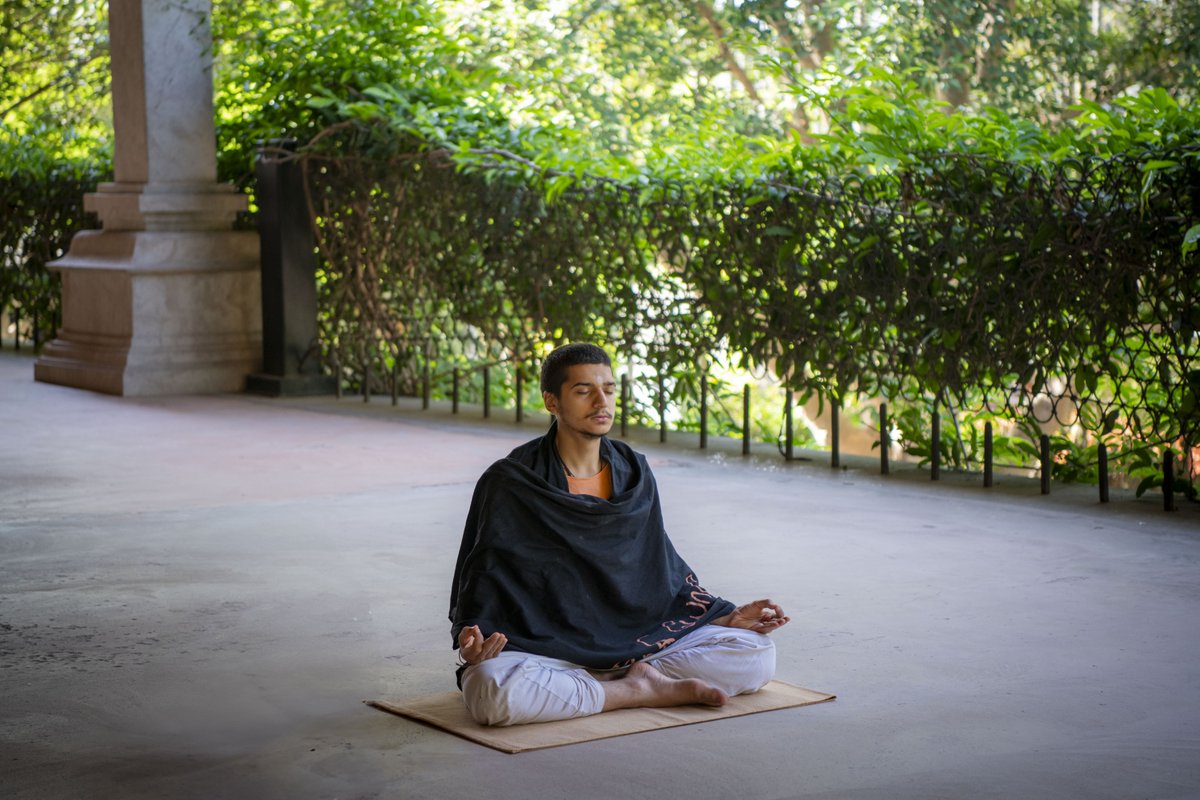 A moment of profound stillness amidst the vibrant bustle of the Isha Yoga Center.
