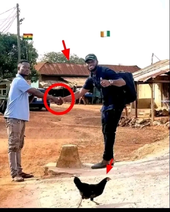 This is the concrete pillar separating Ghana and Ivory Coast in the border town of Badukrom.

These two guys are shaking hands; one is in Ivory Coast, and the other is in Ghana.

The house you see on the other side is built by a man who wants to live in both countries.

There are